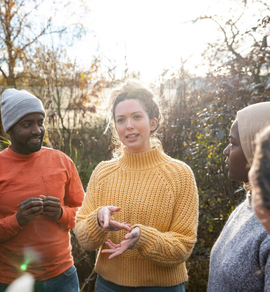 A woman explaining a project to a group of people