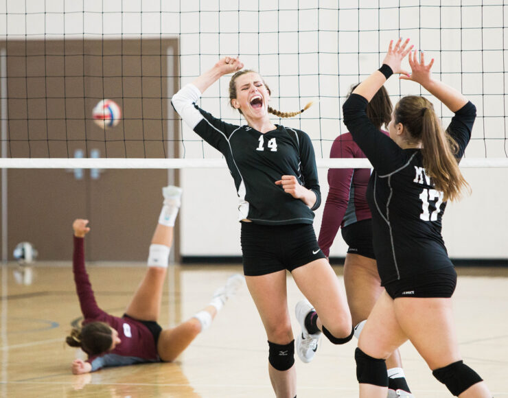 Women's volleyball team in the middle of a match