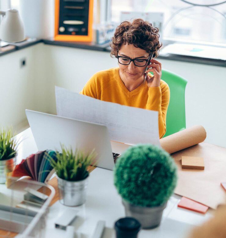 The recruitment process at Blue Soft. A woman on the phone in an office.