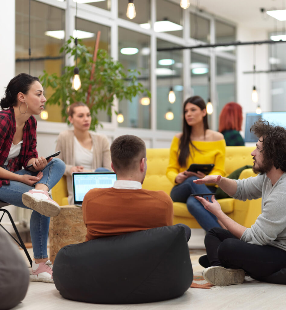 Five people in the middle of a team meeting