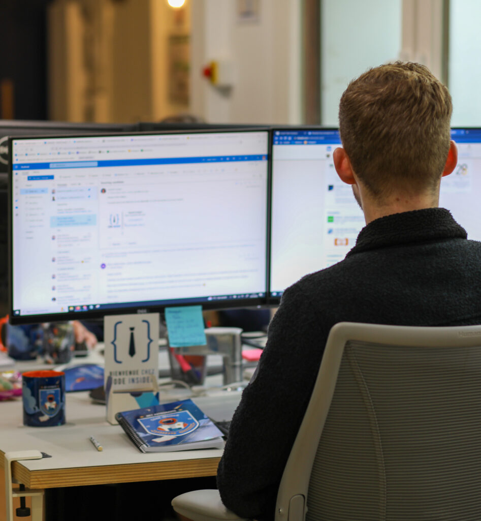 Man with back working on computer