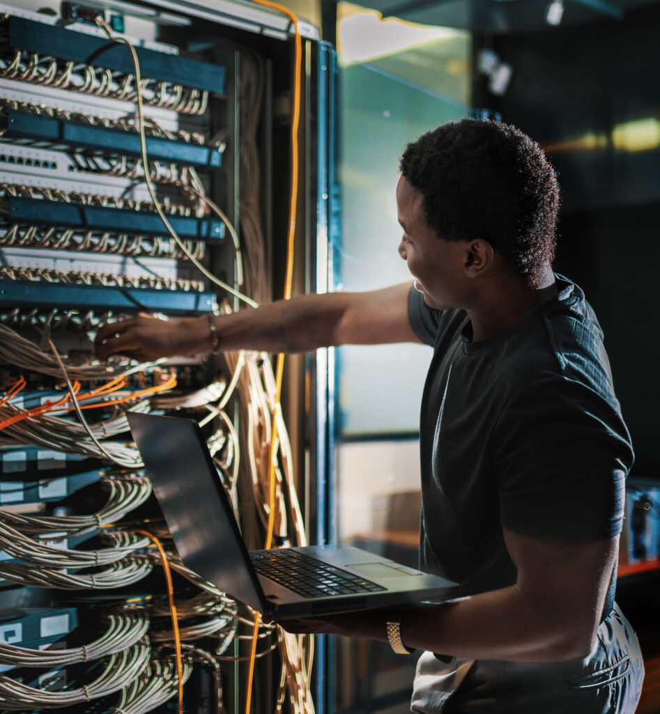 Man with a computer in a datacenter