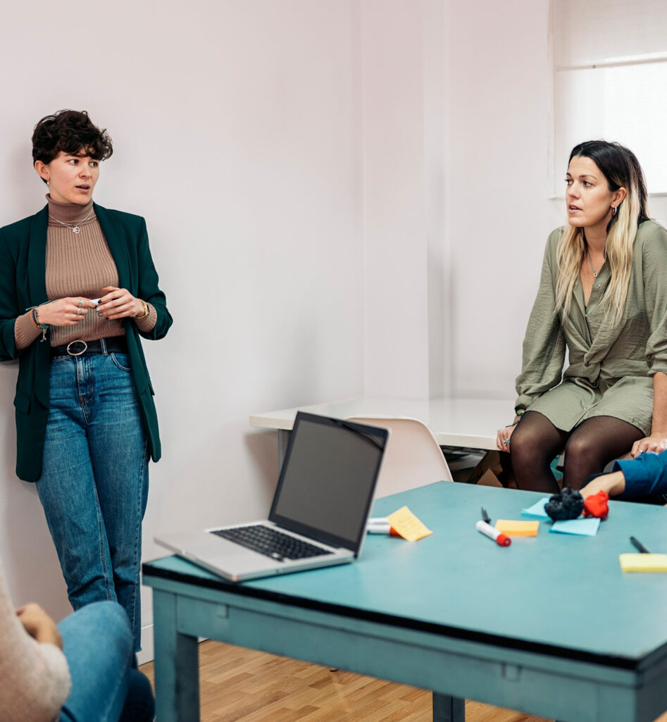 Four people around a table talking