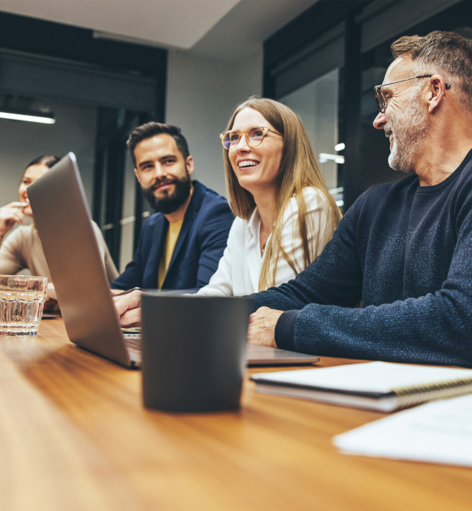 Five people around a table in a meeting