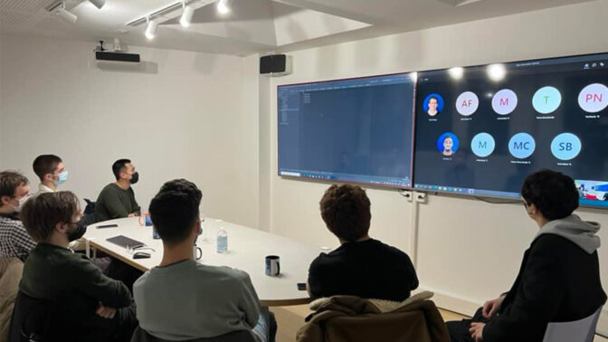 Team around a table during a hybrid meeting