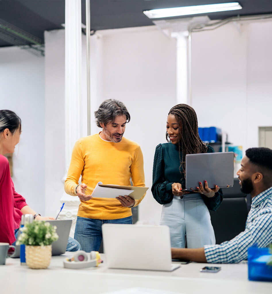 Four people standing at a meeting