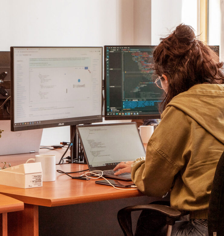 Woman with back working on her computer