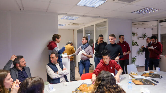 Team around a table sharing galettes des rois