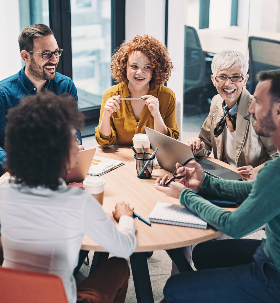 Five people chatting around a table