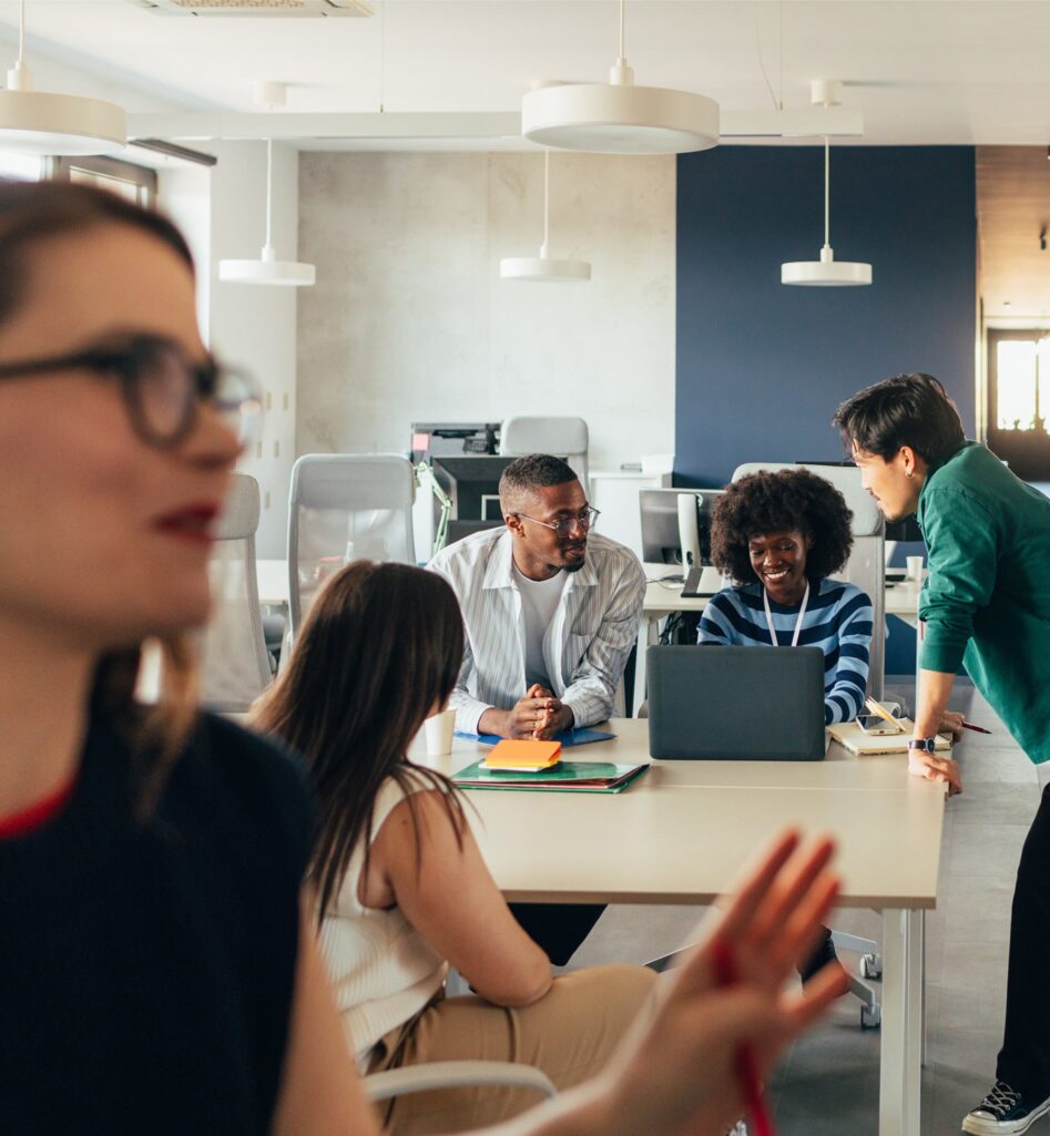 Four people talking at a desk