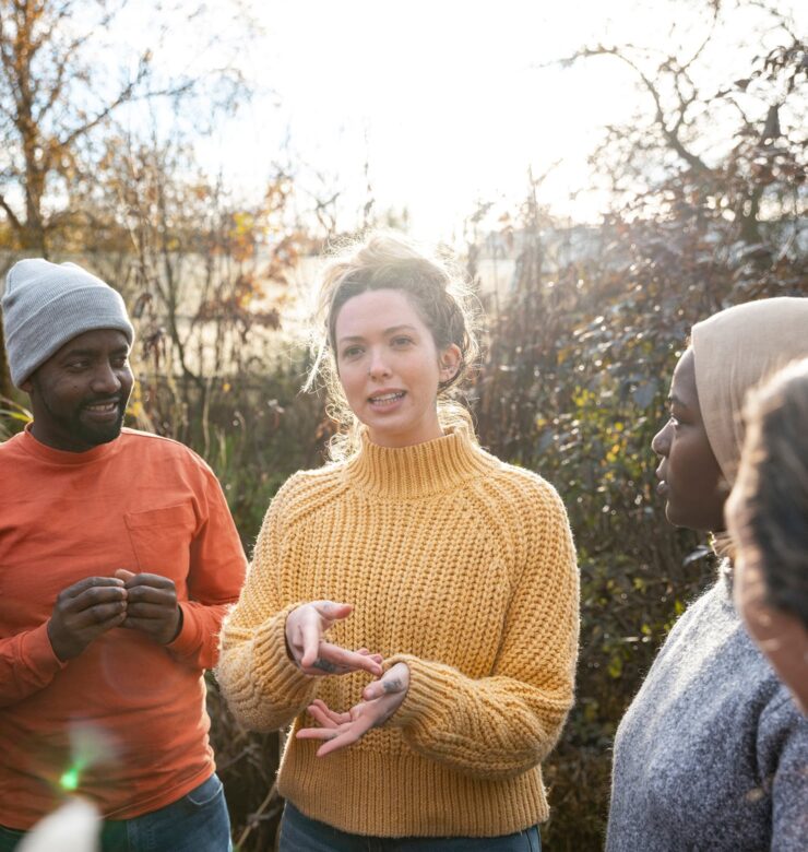 A woman explaining a project to a group of people